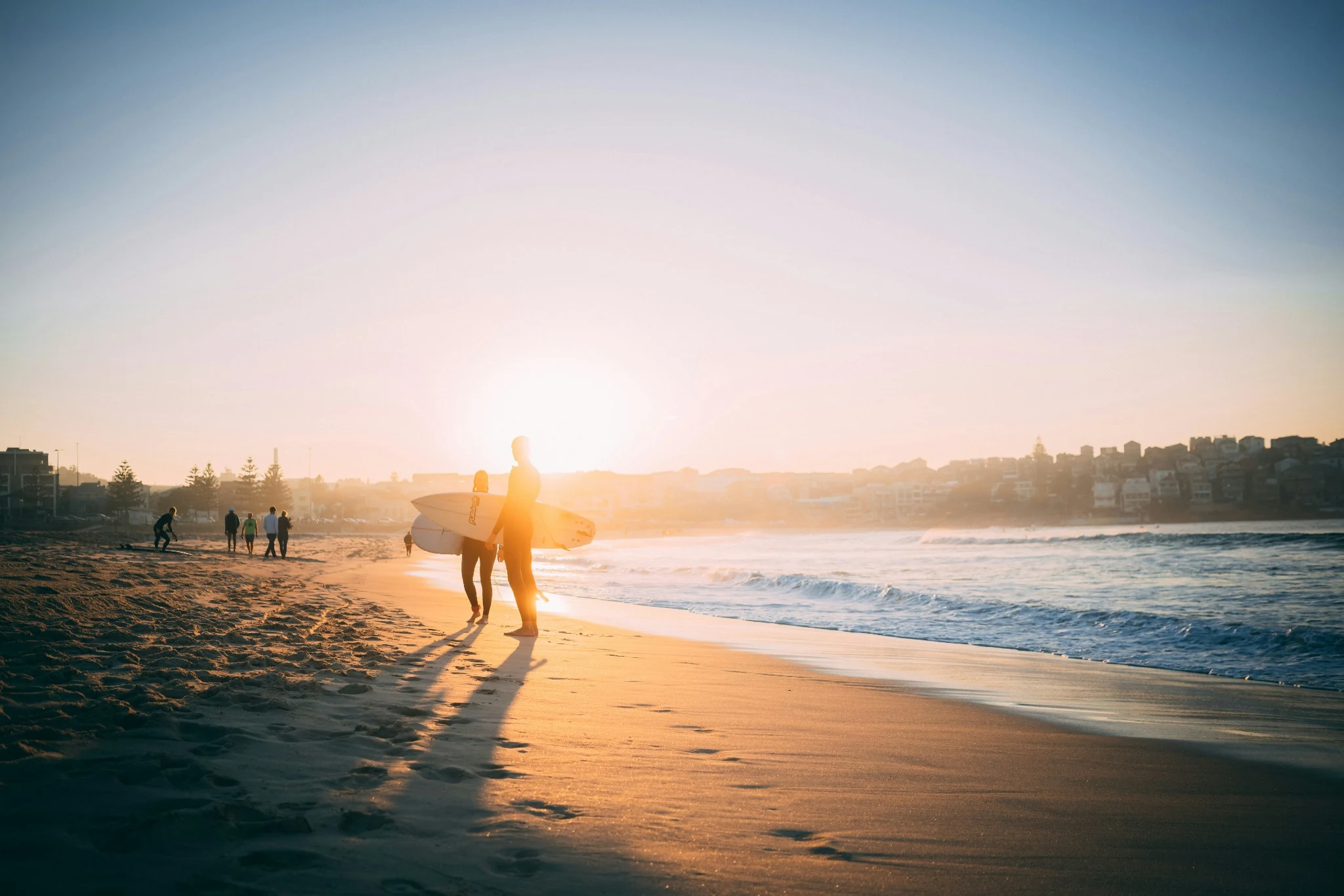 Surfer at sunset on a Sydney beach